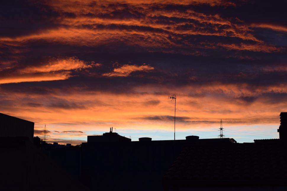 Free Image of Red Sky With Few Clouds in Distance 