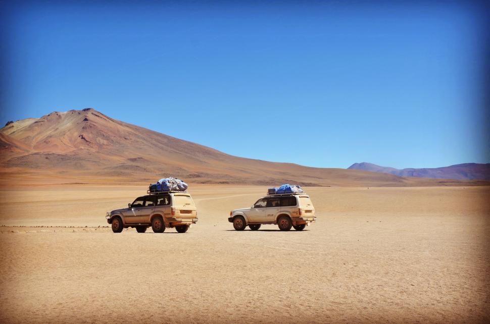 Free Image of Two Abandoned Cars in Dirt 