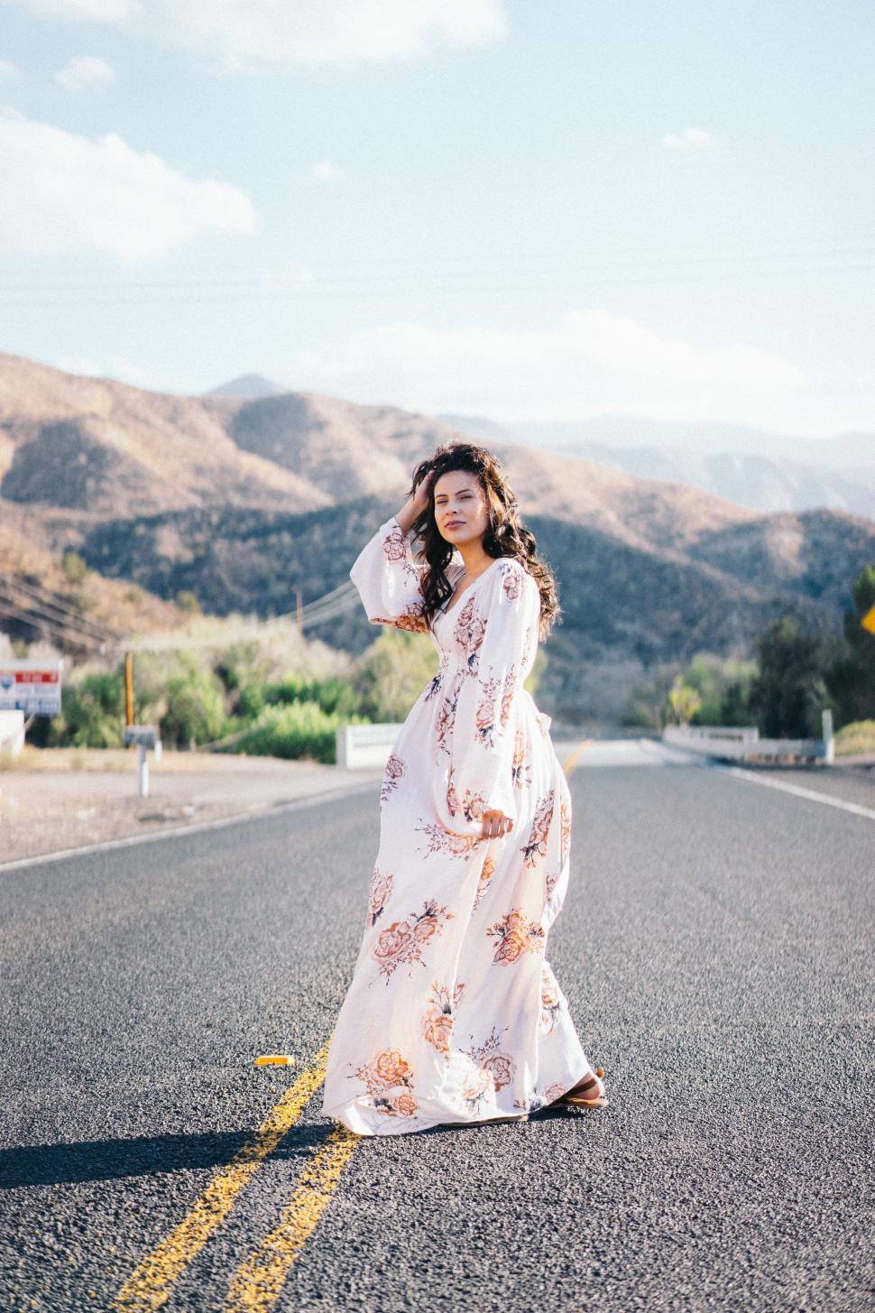 Free Image of Woman Standing in the Middle of a Road 