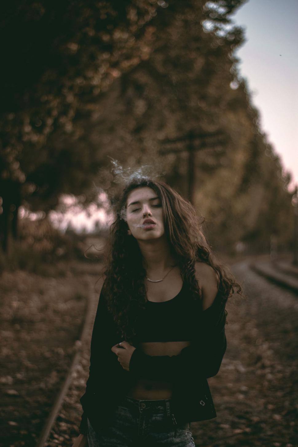 Free Image of Woman Standing on Train Track 
