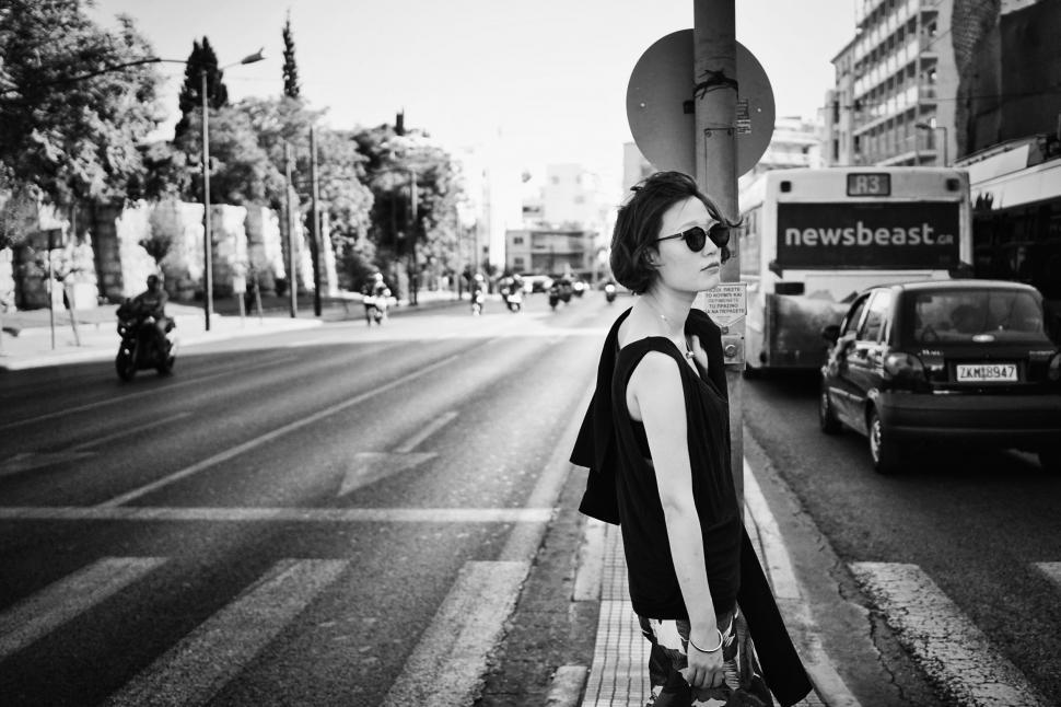 Free Image of Woman Standing on the Side of a Road 