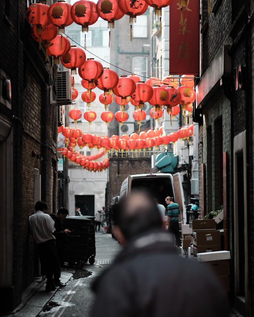 Free Image of Man Walking Down a Narrow Alleyway 