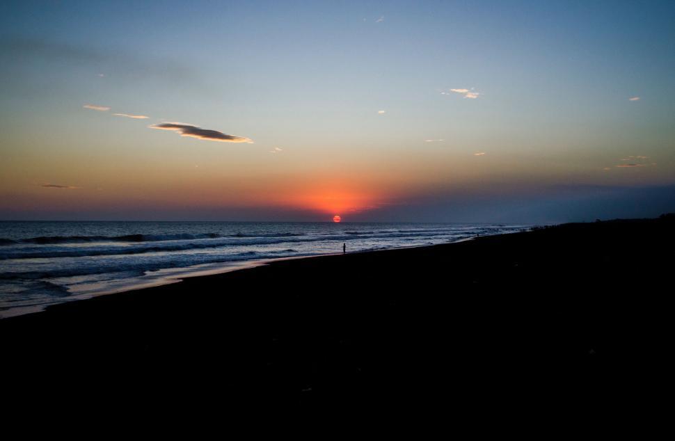 Free Image of Sun Setting Over Ocean on Beach 