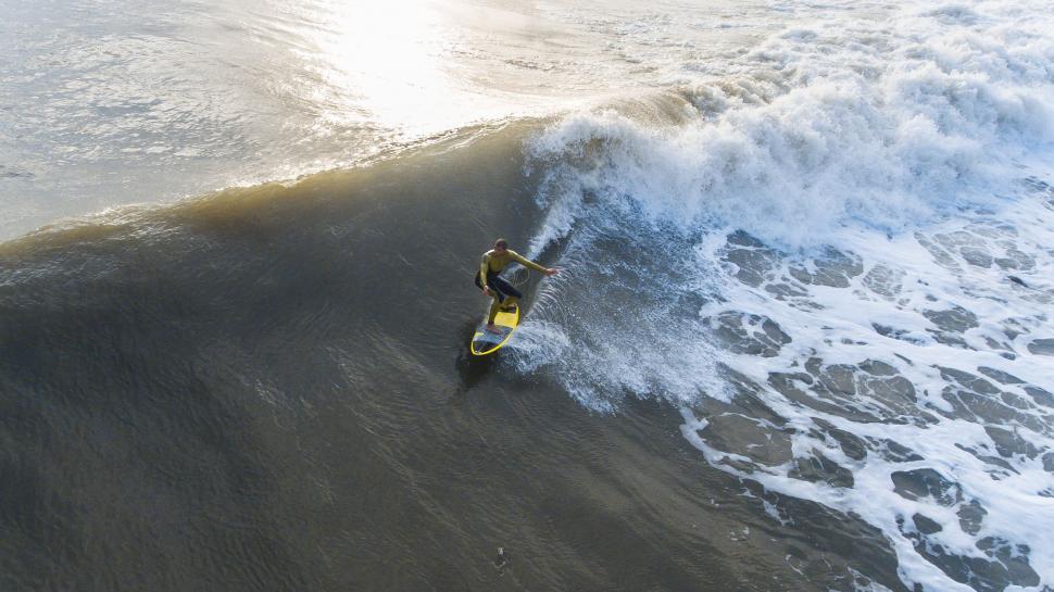 Free Image of Man Riding Wave on Surfboard 