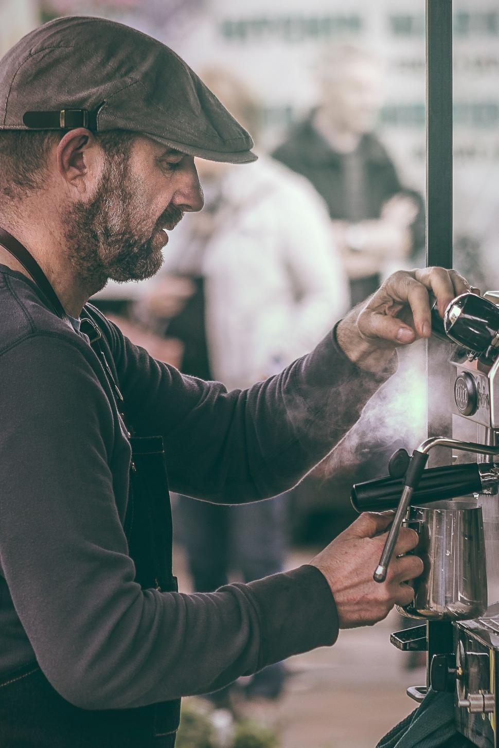 Free Image of Man Operating Coffee Machine 