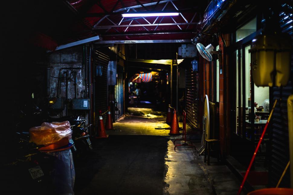Free Image of Dark Alley With Fire Hydrant and Trash Bin 