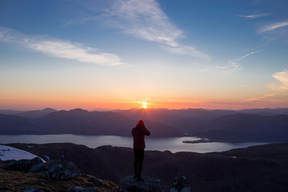 Free Image of Person Standing on Top of Mountain at Sunset 