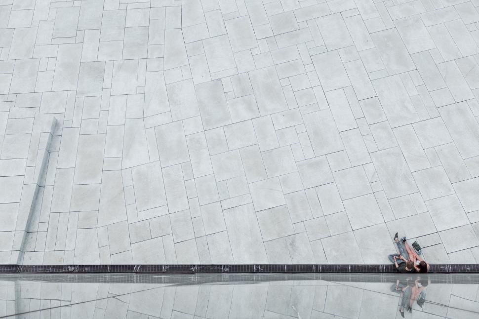 Free Image of Two People Walking Down a Sidewalk in the Rain 