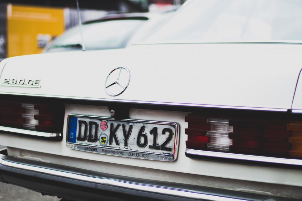 Free Image of White Mercedes Benz Parked on the Street 