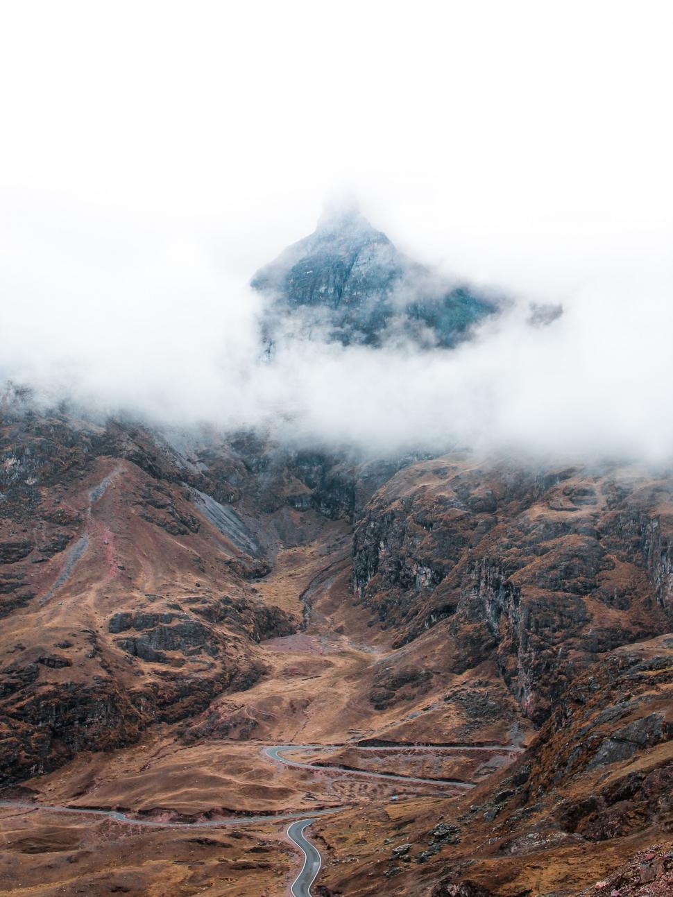 Free Image of Mountain Road Cutting Through Rugged Terrain 