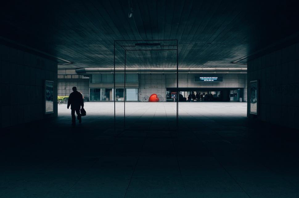Free Image of Man Walking Through Dark Hallway 
