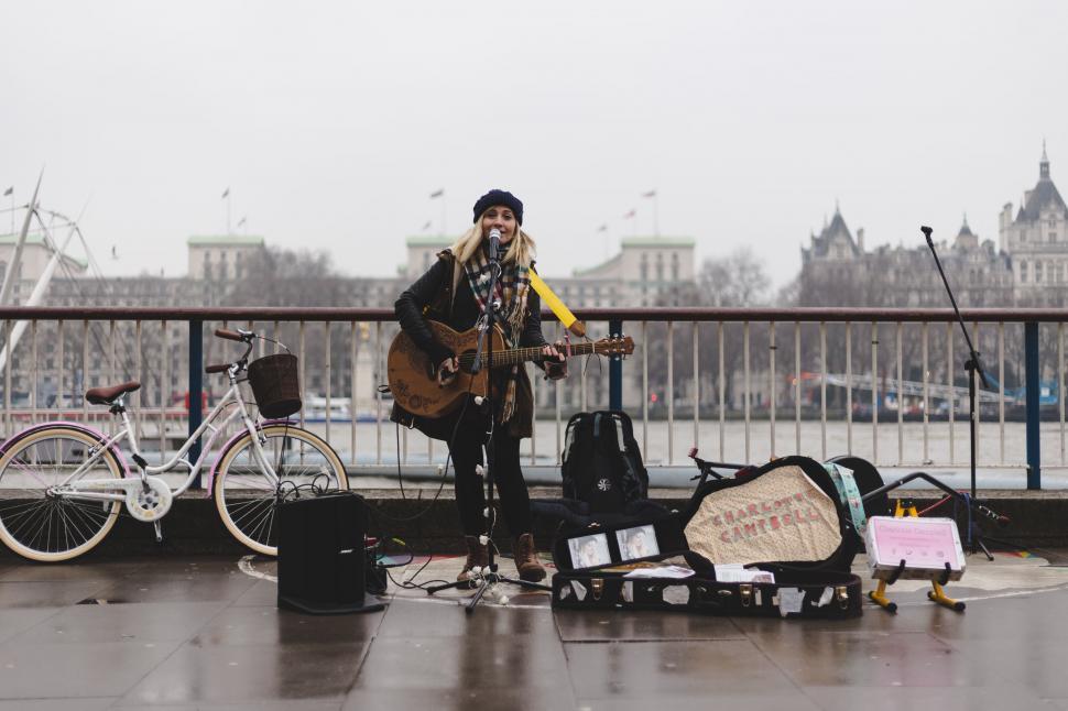 Free Image of Man Playing Guitar on Rainy Day 