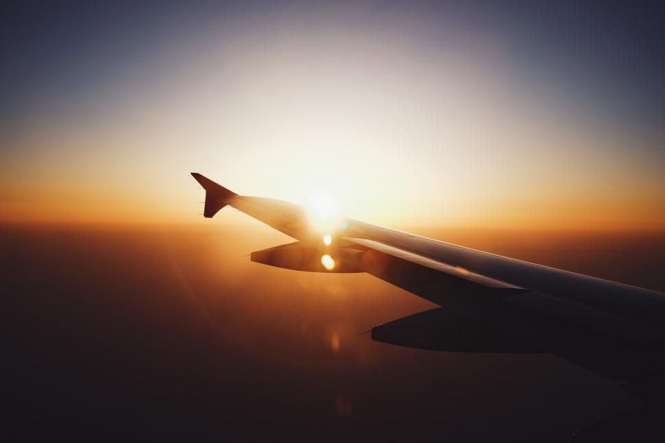 Free Image of The Wing of an Airplane at Sunset 