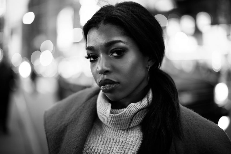 Free Image of Woman Standing on Street Corner With Surprised Expression 