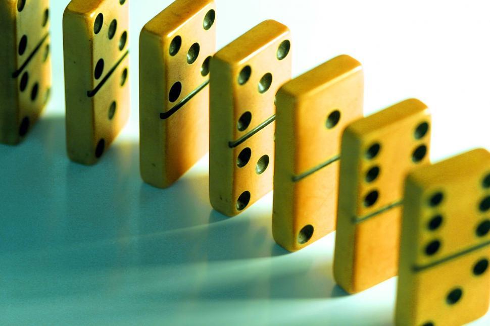 Free Image of A Row of Dominos on a White Surface 