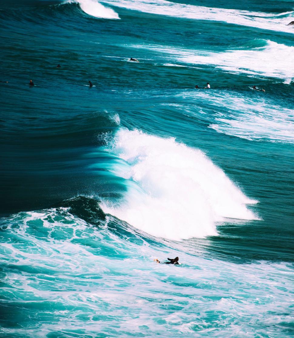 Free Image of Person Riding Wave on Surfboard 