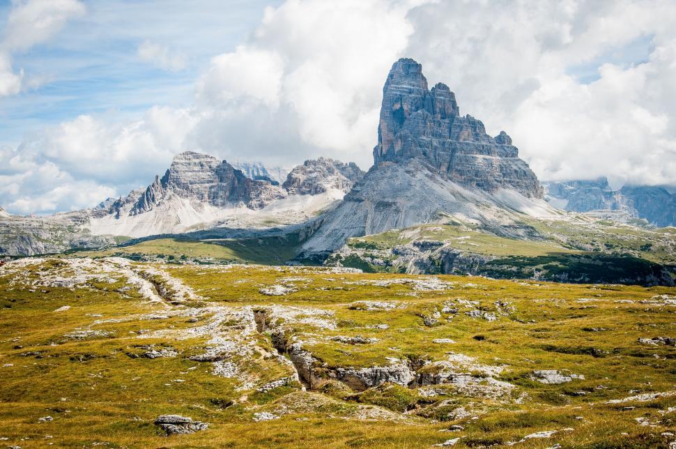 Free Image of Grassy Field With Mountain in Background 
