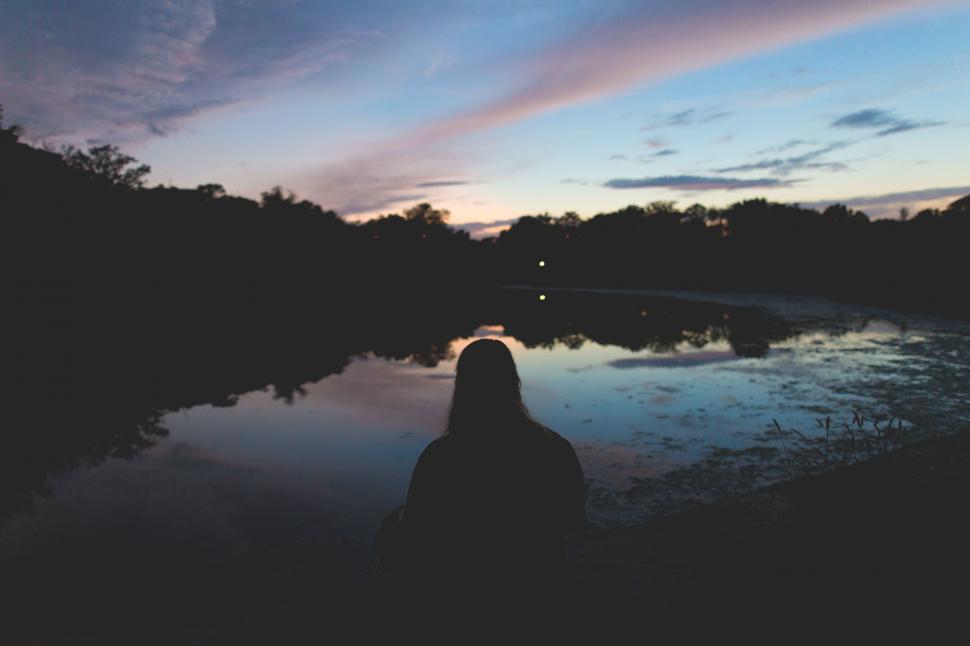 Free Image of Person Standing In Front Of Body Of Water 