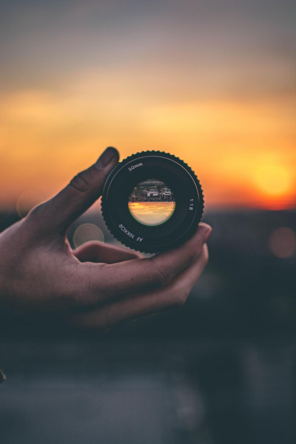 Free Image of Person Holding Camera Lens 
