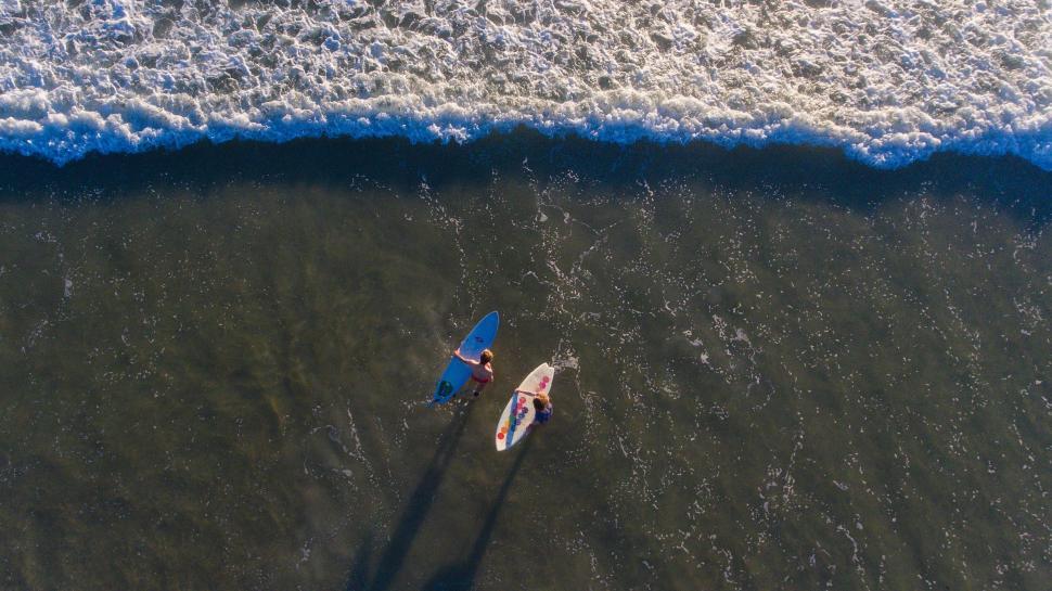 Free Image of Two People Surfing in the Ocean 