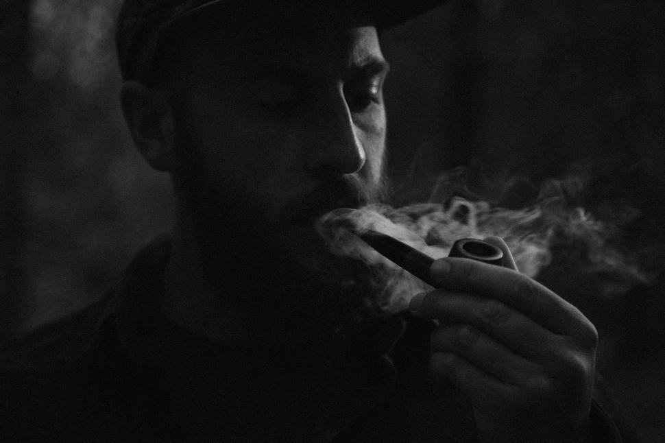Free Image of Man in Hat Smoking Cigarette 