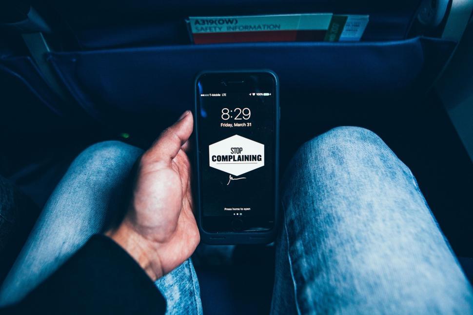 Free Image of Person Sitting in Car Holding Cell Phone 