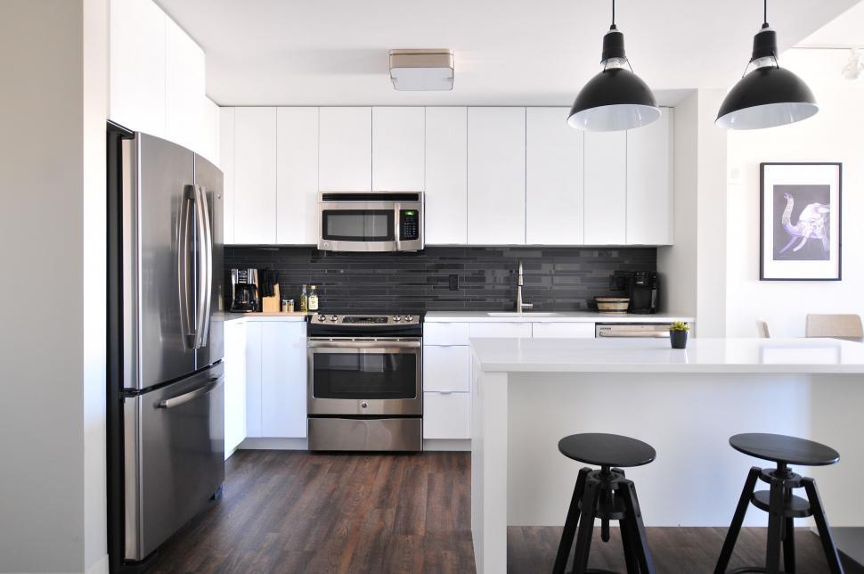 Free Image of Kitchen With Refrigerator and Two Stools 