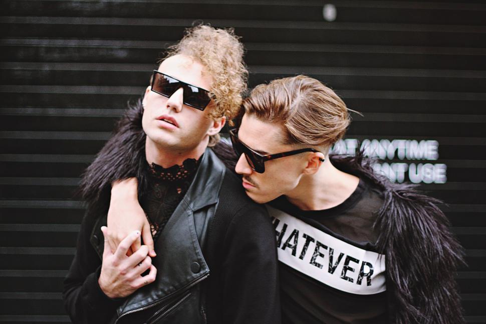 Free Image of Two Men in Black Jackets and Sunglasses Standing Together 