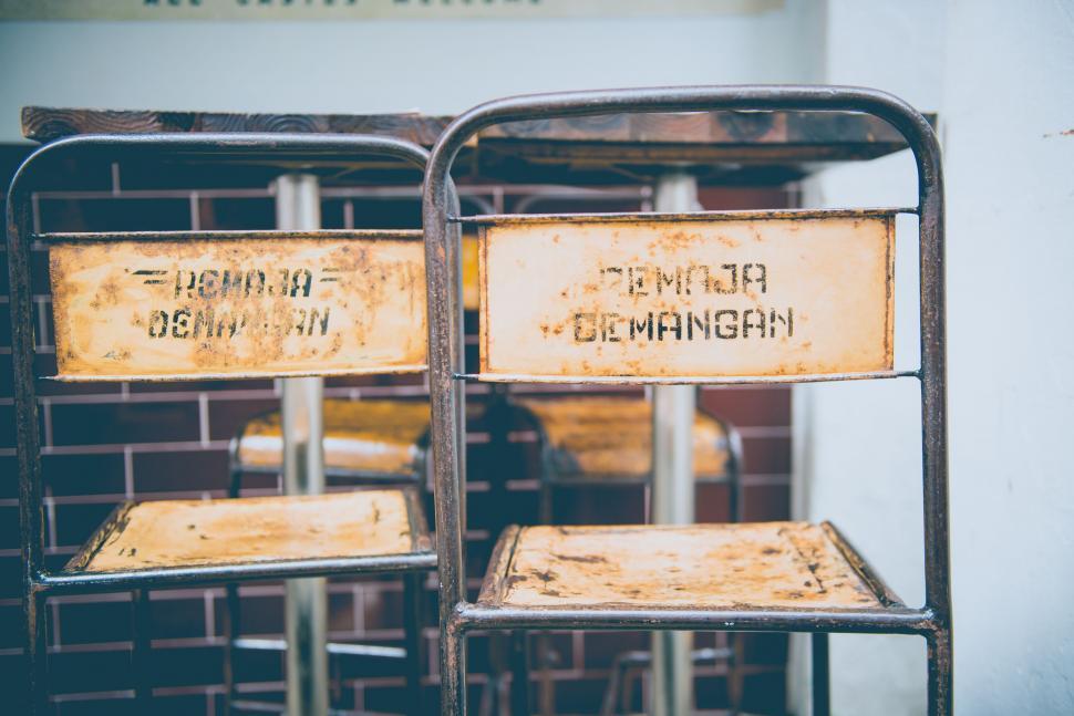 Free Image of Three Rusty Metal Signs on Metal Rack 