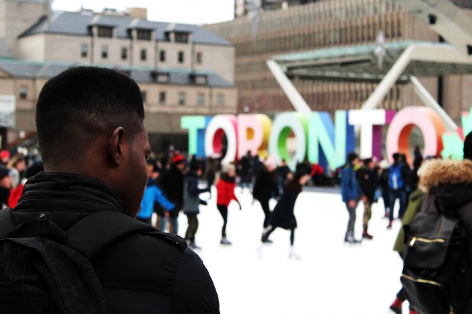 Free Image of Group of People Standing in Front of a Sign 