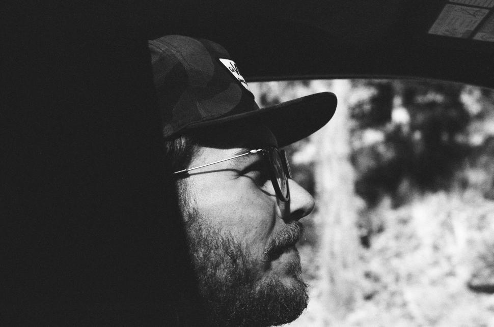 Free Image of Man With Hat and Glasses Sitting in Car 