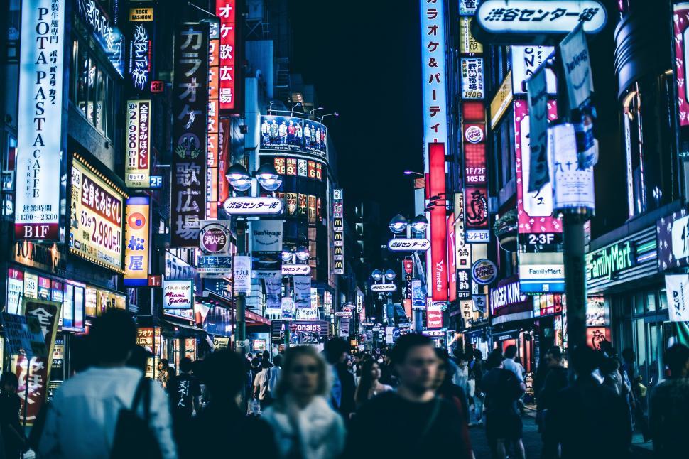 Free Image of Bustling City Street Teeming With Neon Signs 