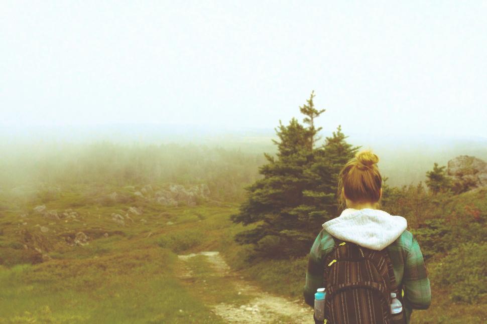 Free Image of Person With Backpack Walking Up a Trail 