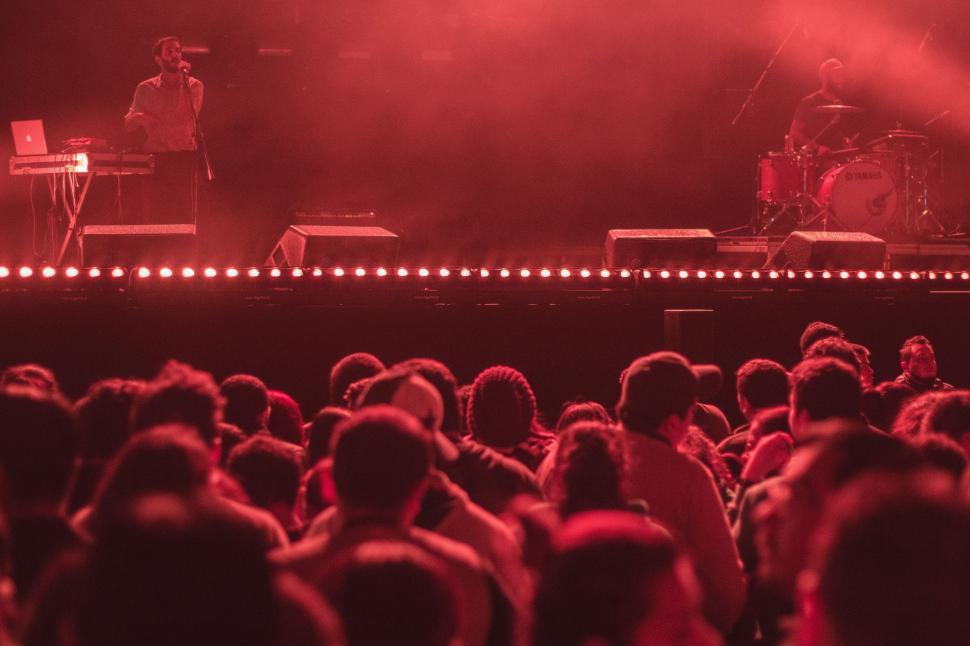 Free Image of Group of People Standing on Top of a Stage 