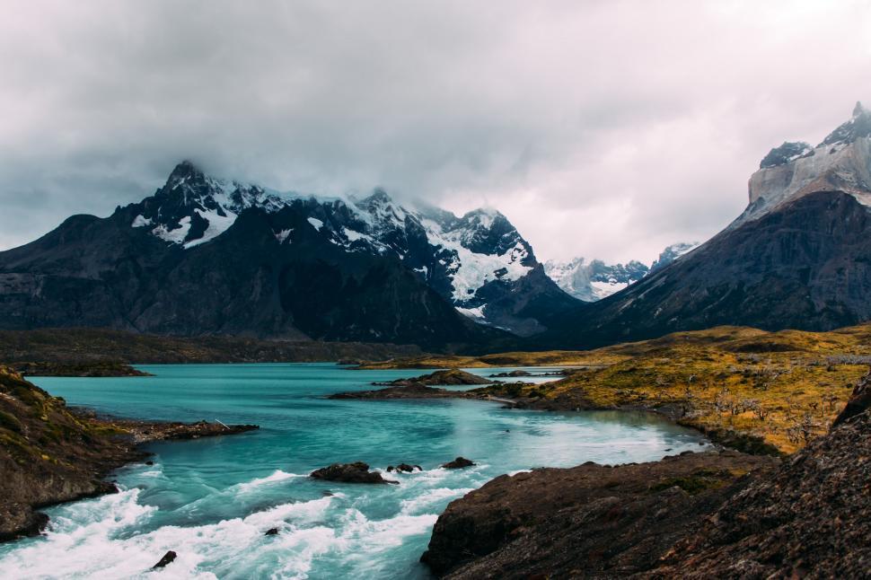 Free Image of River Flowing Through Valley Surrounded by Mountains 
