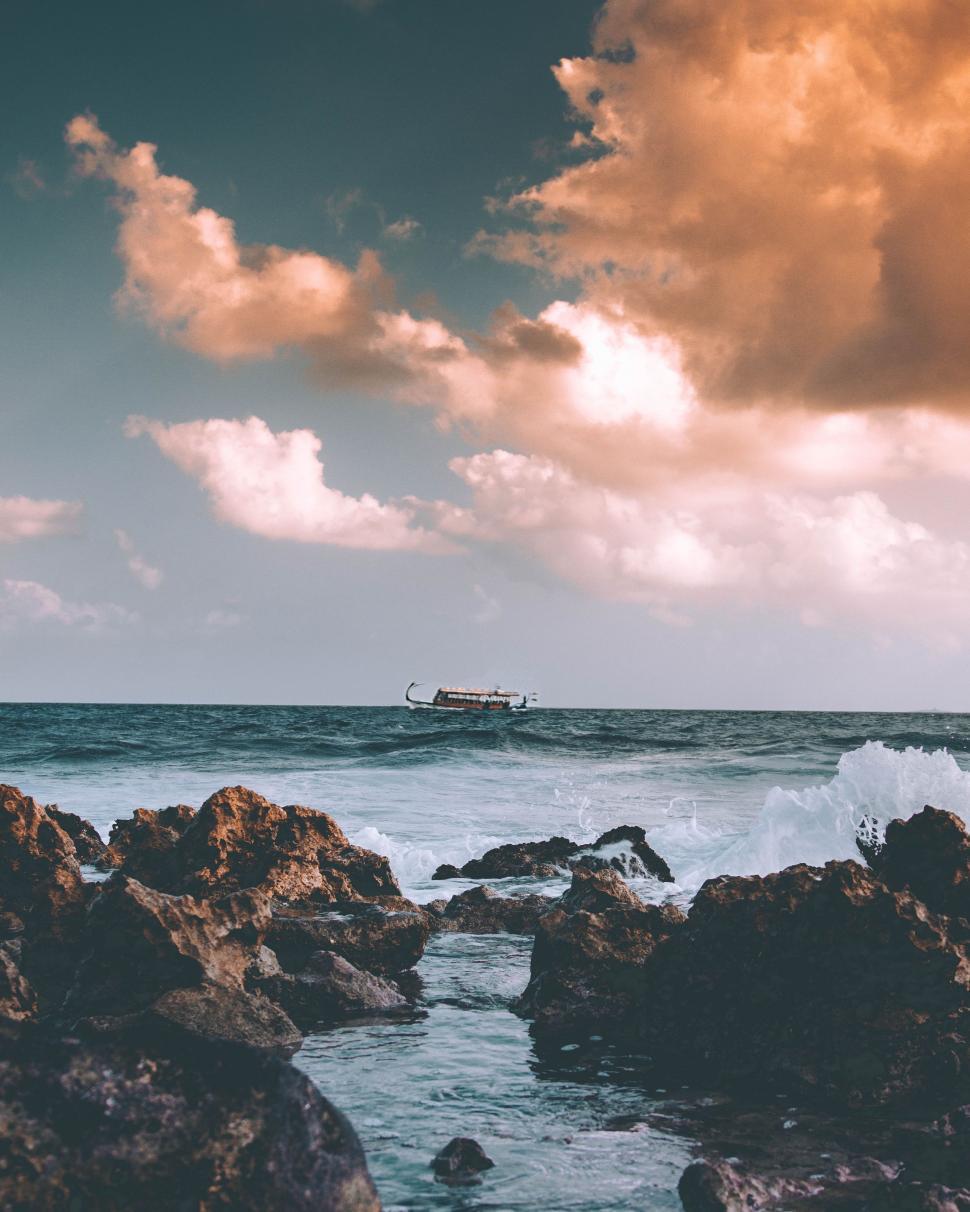 Free Image of Boat Sailing on the Distant Ocean 
