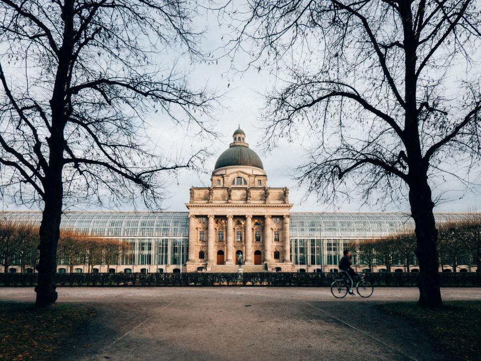 Free Image of Person Riding Bike in Front of Building 