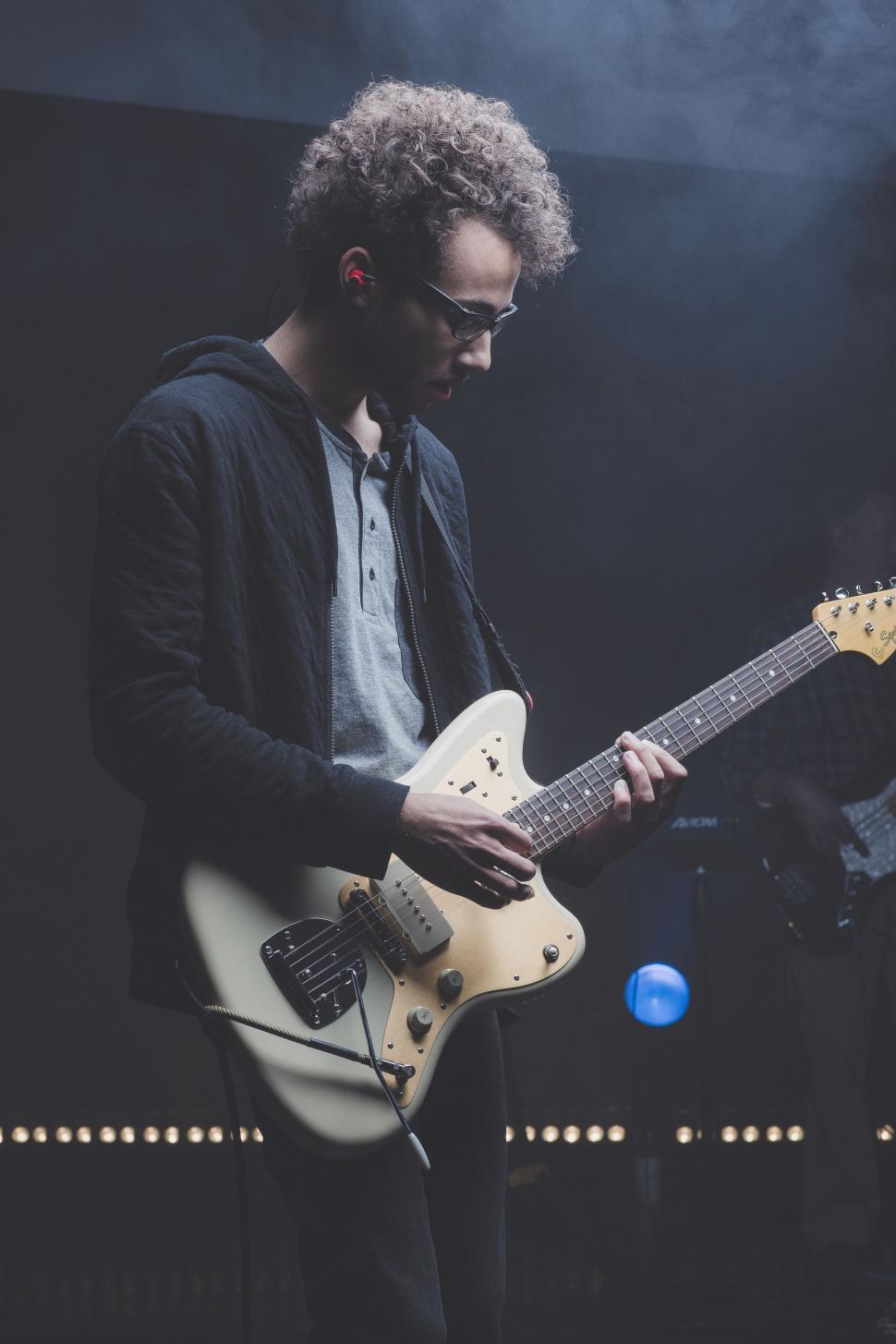 Free Image of Man Playing Guitar on Stage 