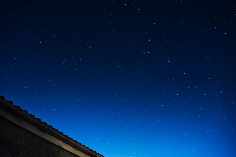 Free Image of Person Snowboarding on Roof at Night 