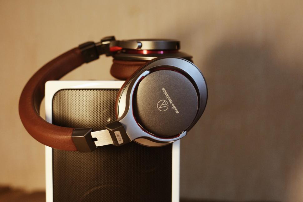 Free Image of Headphones Resting on Speaker 