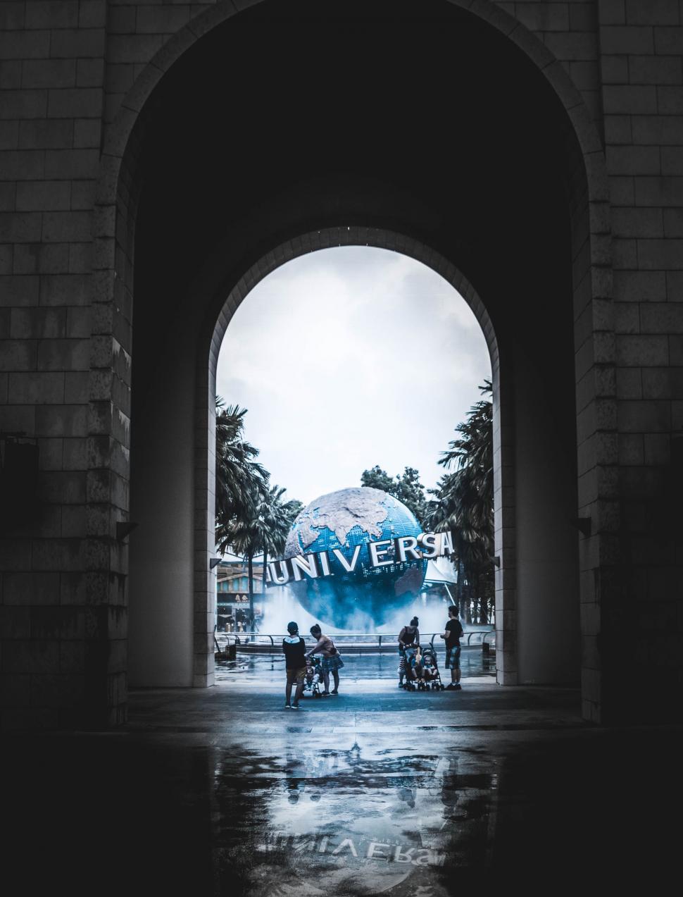 Free Image of People Walking Under Archway 