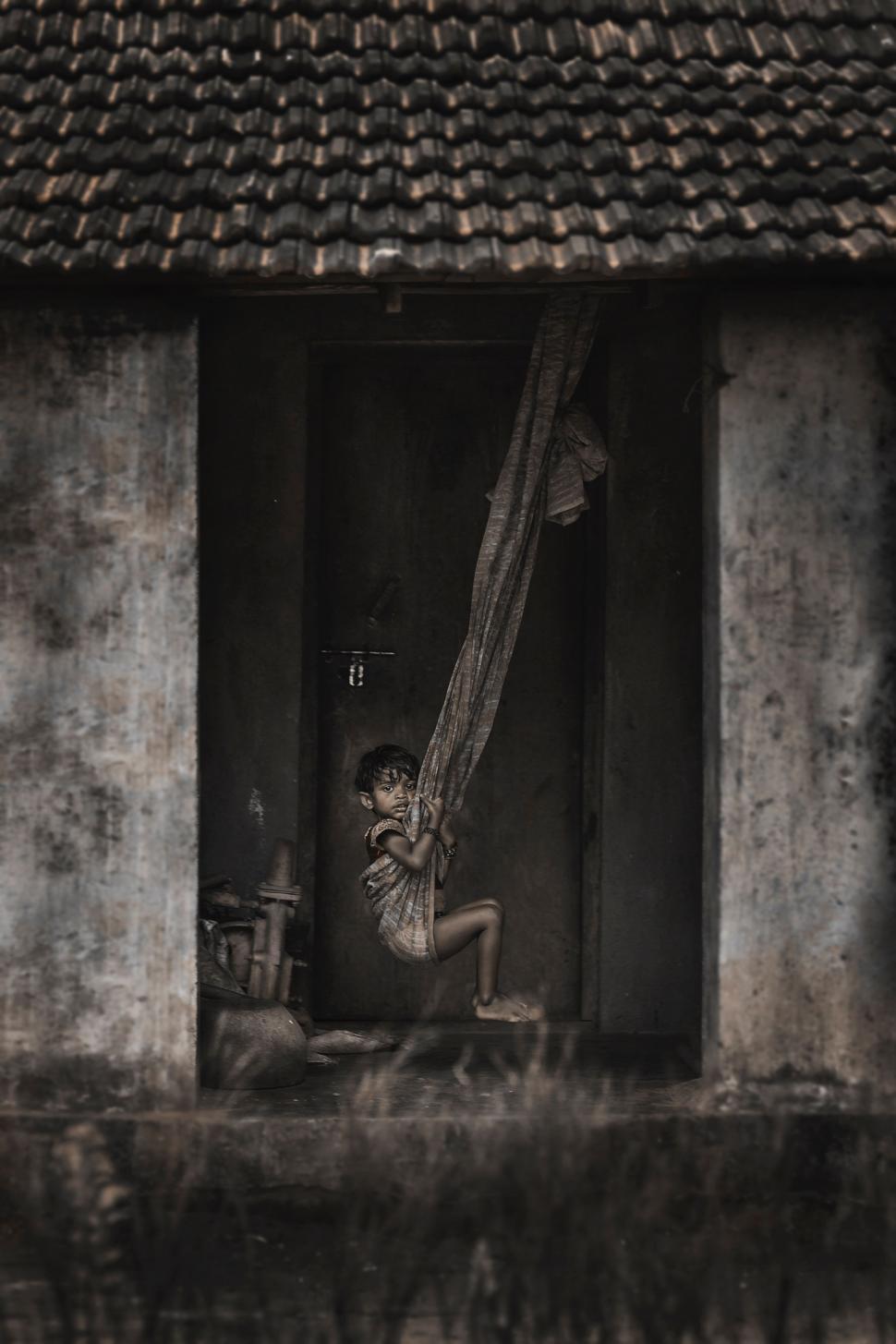 Free Image of Person Looking Out Window in Black and White 