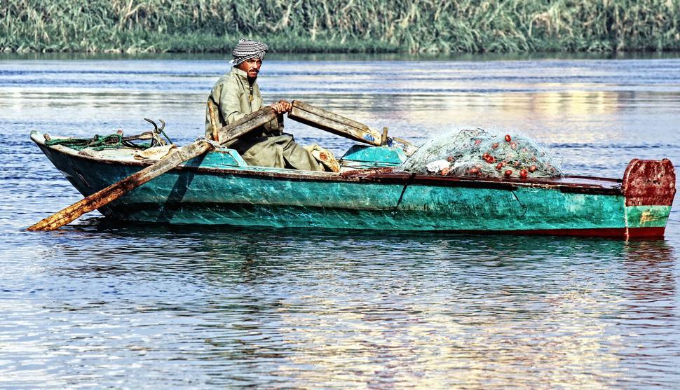 Free Image of Man Sailing in Green Boat on Lake 