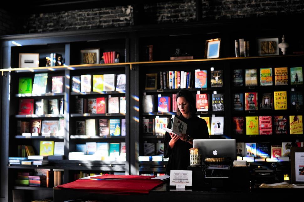 Free Image of Man Reading Book in Library 