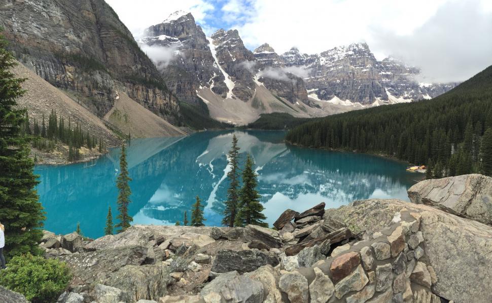 Free Image of Man Standing on Mountain Top by Lake 