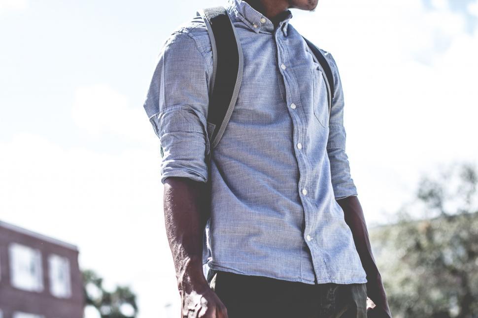 Free Image of Man Walking Down Street With Backpack 