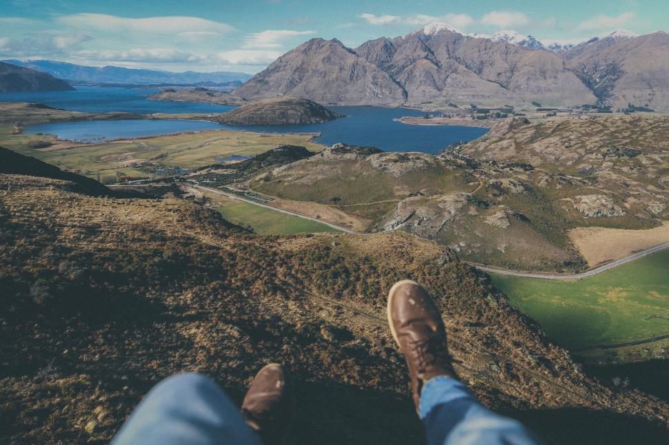 Free Image of Person Standing on Mountain Overlooking Lake 