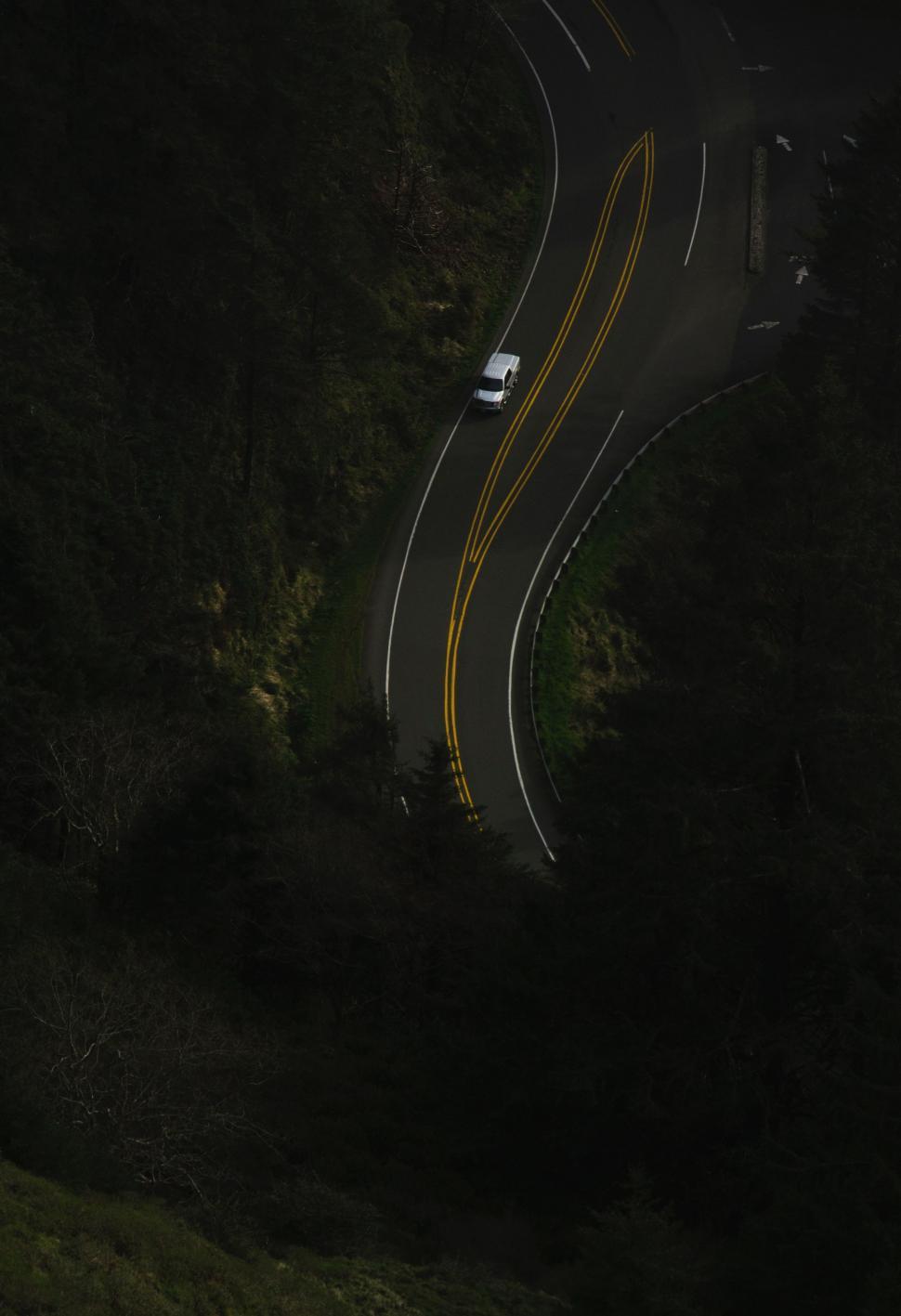Free Image of Car Driving Down Road at Night 