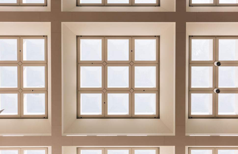 Free Image of Man in Suit and Tie Standing in Front of Window 