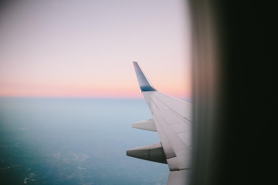 Free Image of Airplane Wing Flying Over the Ocean 